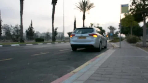 Car with emergency lights on the side of road near the curb. unfocused 스톡 동영상 203125219