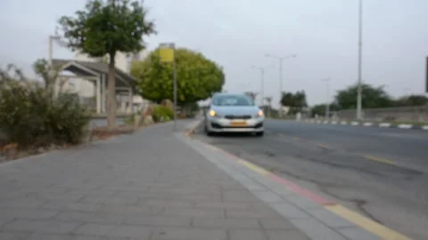 Car with emergency lights on the side of road near the curb. unfocused 스톡 동영상 203125372