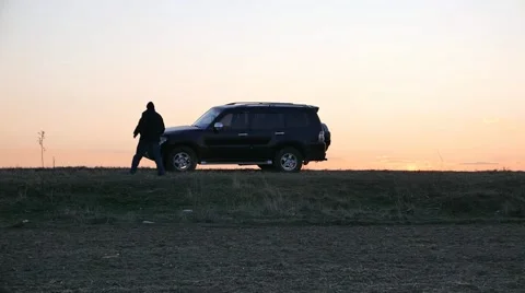 The car is emergency stoping  in a field at sundown Stock Footage 58973645