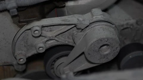 Car engine accessory drive serpentine belt automatic tensioner assembly brack Stock Footage 344595953