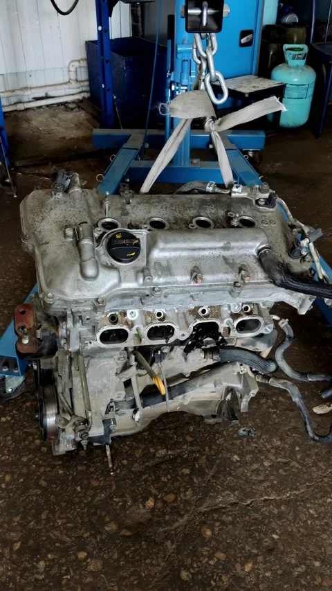 A car engine assembly hanging on a crane in workshop. Stock Footage 339491862
