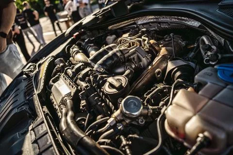 Car engine bay showing complex mechanical parts Stock Photos