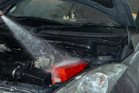 Car engine being washed with water Stock Photos