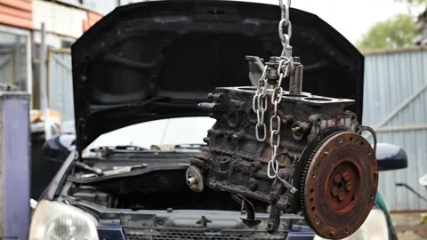Car engine block hanging from chain for repair Video stock 320494546