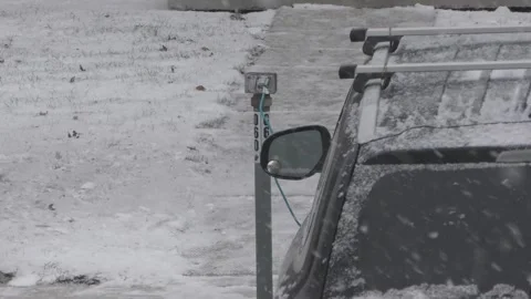 A car with engine block heater cable outside in winter 動画素材 326339540