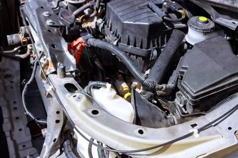 Car engine components mechanics hard at work in garage on fixing issues Stock Photos
