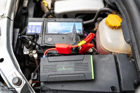 Car engine with a diagnostic tool attached. The tool is a small black box wit Foto stock