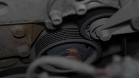 Car engine drive serpentine belt running on metal ribbed pulley. Stock Footage 344596017