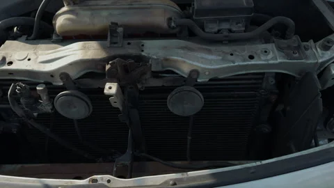 Car engine exposed. Engine bay open with visible wiring and mechanical parts Stock Footage 332355002