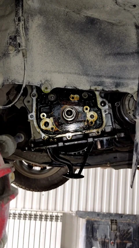 Car engine oil pump seal replacement process with oily surfaces Stock Footage 334321400
