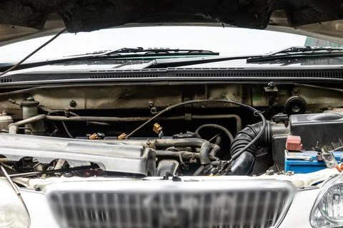 A car engine is open and the hood is up Stock Photos