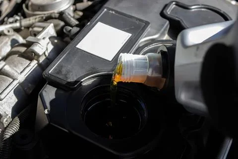 Car engine with open oil cap and dipstick for oil check Фото