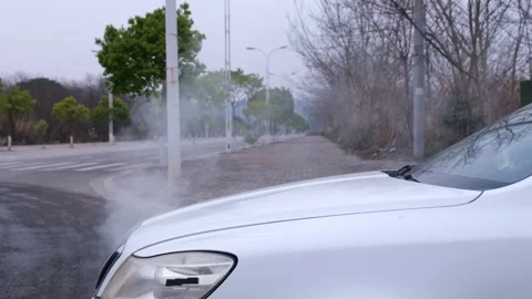 The car engine overheats and steams, damaged engine keeps blowing white smoke. Stock Footage 329163670