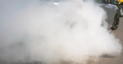 Car Engine Revving with Tire Spinning and Thick Smoke Cloud Stock Footage 315491572
