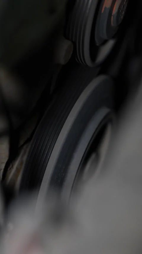 Car engine serpentine belt running on metal pulleys close view. Stock Footage 344594972