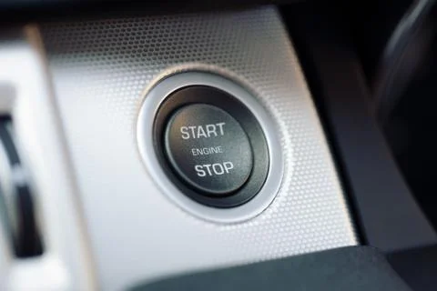 Car engine start and stop button on a hybrid car Stock Photos