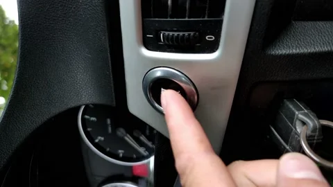 Car engine start button. Driver presses start-stop button in car. Close-up of Stock Footage 164085260