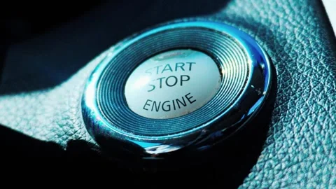 Car engine start stop button on black textured dashboard Video stock 338019169