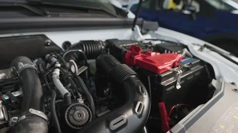 Car engine under the hood of a modern car. New car in the showroom. Stock Footage 202264473