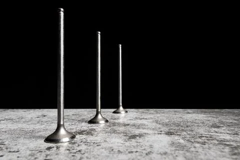 Car engine valves on the table and black background. Part of an internal Stock Photos