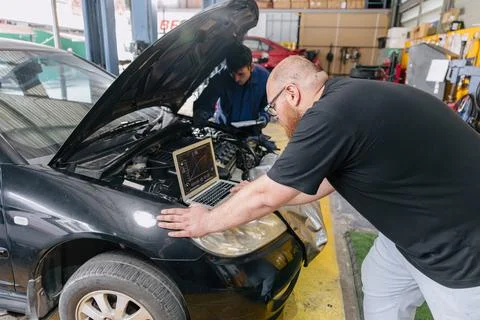 Car engineer technician worker, Technician team use laptop computer for tun.. Stock Photos