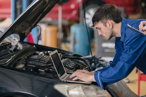 Car engineer technician worker, Technician team use laptop computer for tun.. Stock Photos