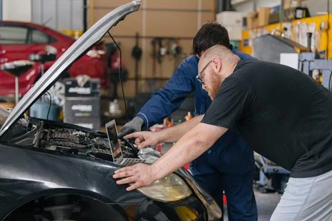 Car engineer technician worker, Technician team use laptop computer for tun.. Stock Photos