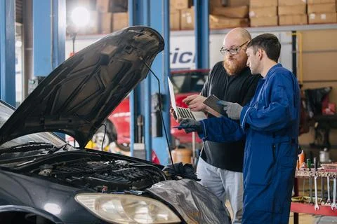 Car engineer technician worker, Technician team use laptop computer for tun.. Stock Photos