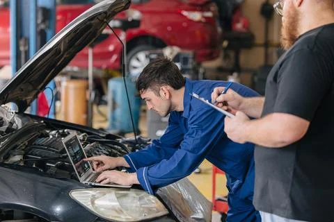 Car engineer technician worker, Technician team use laptop computer for tun.. Stock Photos
