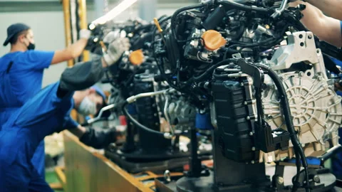 Car engines are getting assembled by factory workers. Automobile factory, car Vídeo Stock 141120203