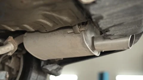 A car exhaust muffler with a chrome tailpipe visible from Stock Footage 340977940