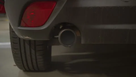 Car Exhaust Pipe Emitting Grey Smoke and Loud Engine Starting Sound Close Up 動画素材 327648280