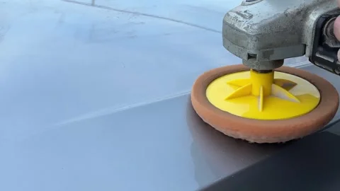 Car expert using a car polisher to polish the bonnet. Refinement like a new car Stock Footage 307276478