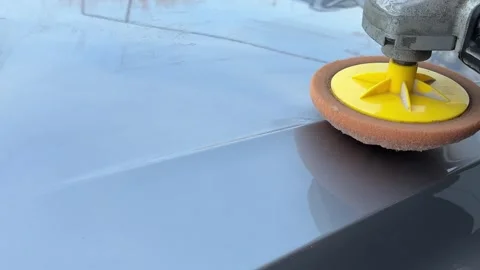 Car expert using a car polisher to polish the bonnet. Refinement like a new car Stock Footage 309103307