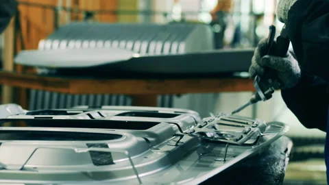 Car factory worker applying structural adhesive on a car part Stock Footage 143244648