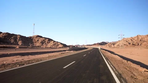 Car fast driving on the empty asphalt highway in the desert with road surface Stock Footage 251970028