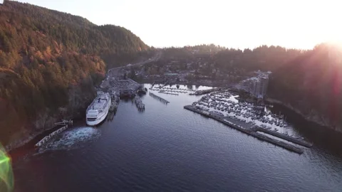Car ferry boat sailing into dock in scenic bay surrounded by mountains, sun rays 스톡 동영상 221717475