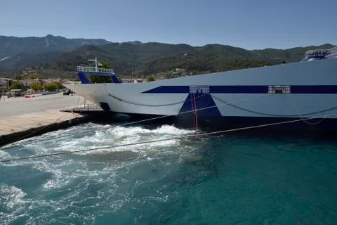 Car ferry in harbor using propellers to adjust its place Stock Photos