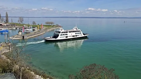 Car ferry leaving harbor with passengers in Romanshorn Видео 332264033