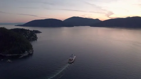 Car ferry on the ocean with a beautiful ocean and mountain view at sunset, Howe Stock Footage 249728366