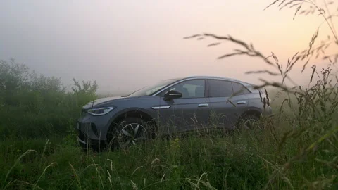 Car in the field at dawn Stock Footage 201029040