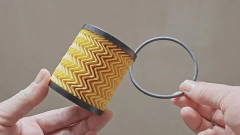 A car filter insert with a rubber gasket held in hands, showing details on .. Stock Footage 310165736