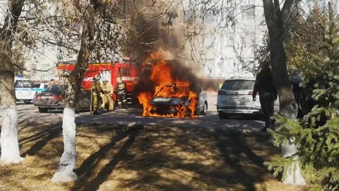 Car on fire. car is engulfed in flames in a residential neighborhood Stock Footage 289278216