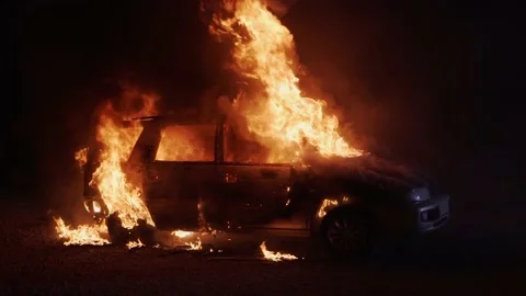 Car on fire slow motion. Burning automobile. Side view car at night Stock Footage 227159177