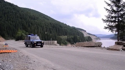 Car with flashing and sirens started going at speed on a mountain road. Comes Stock Footage 88330428