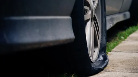 Car with flat tire on pavement 스톡 동영상 252592441