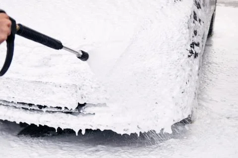 Car in foam and detergent bubbles at the sink Stock Photos