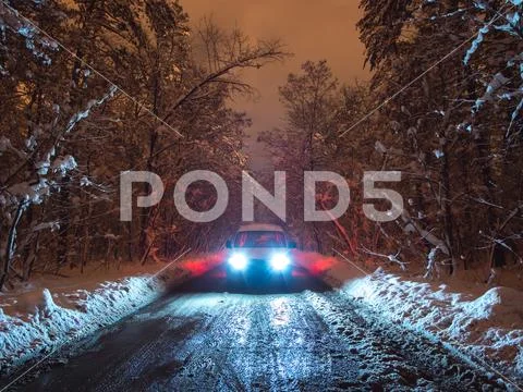 The car on the forest road. evening night time Stock Photos