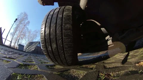 Car Front Tyre and Suspension System When Driving on Openwork Plates Road POV Stock Footage 144530702