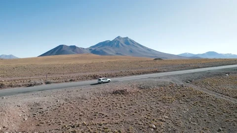 Car in front of Volcanic mountains in San Pedro de Atacama Chile Stock Footage 237307985